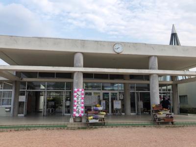 校舎の入り口の左の柱に、入学式式場と縦書きの看板が設置されている写真